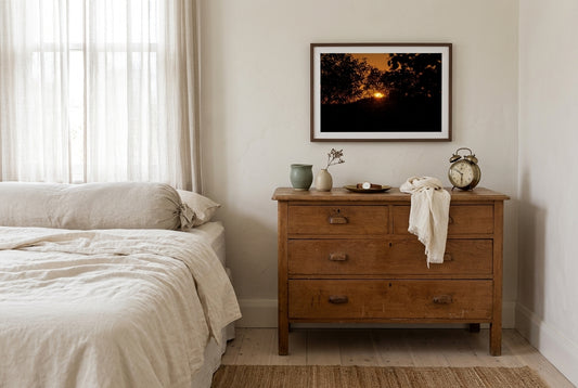Ember Set at Buddy's Lookout, El Questro, framed above a vintage oak dresser in a master bedroom corner — hand-thrown ceramics, ivory linen scarf, layered textiles, dark wood frame. — Two Fat Bunnies.