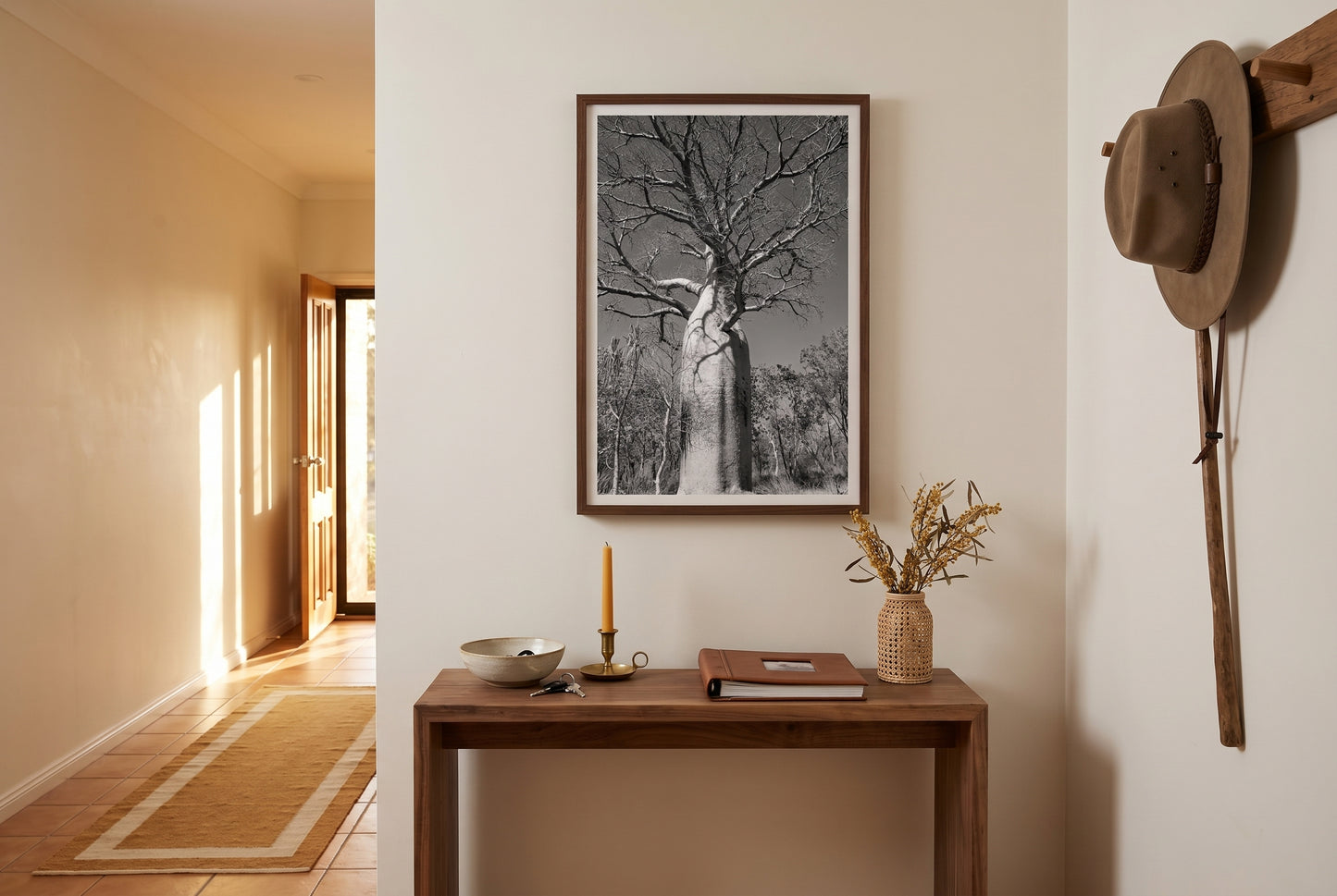 Ancient Sentinel — El Questro Boab, framed above a slim walnut console in a welcoming Australian arrival hallway — terracotta tile, ochre runner, brass candle, dark wood frame. — Two Fat Bunnies.