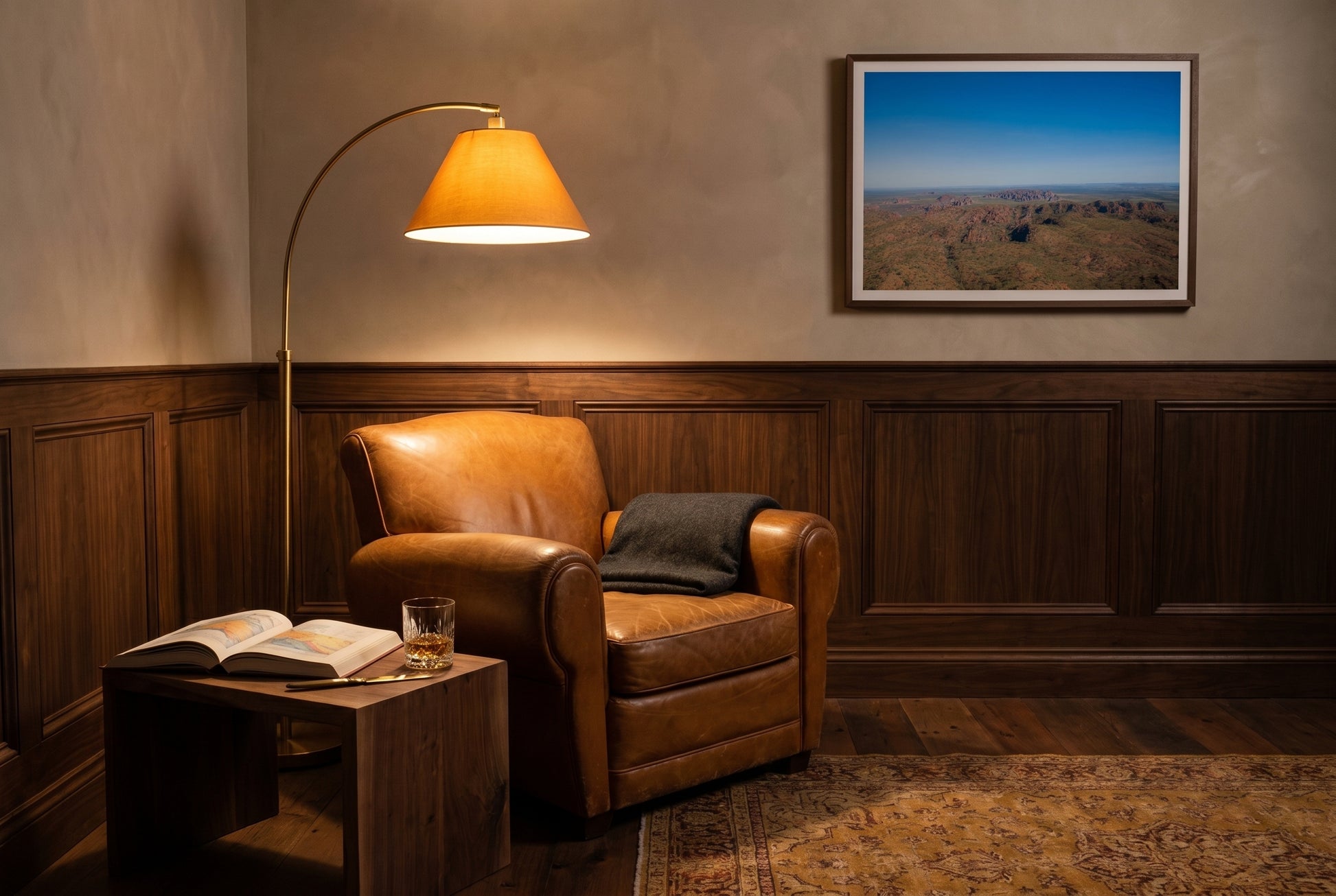 Beehive Domes from Above, framed beside a tan-leather club chair in an intimate study reading nook — brass arc floor lamp, walnut side table, geological atlas, dark wood frame. — Two Fat Bunnies.
