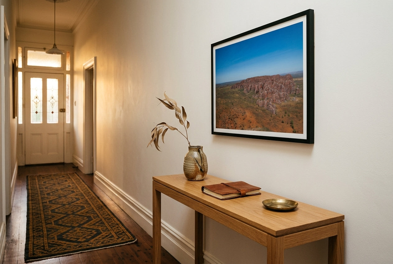 Bungle Bungles From Above, framed above a slim oak console in a Melbourne terrace hallway — patterned ochre-and-charcoal runner, dark spotted gum floor, dark wood frame. — Two Fat Bunnies.