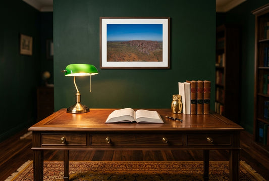 Bungle Bungles From Above, framed above a polished walnut desk in a lawyer's home office — brass banker's lamp, leather-bound legal volumes, deep British-racing-green walls, dark wood frame. — Two Fat Bunnies.