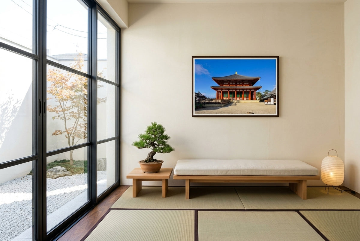 Central Golden Hall at Kōfuku-ji, Nara, framed in a Japanese-inspired sun-room overlooking a dry-stone garden — steel-framed glass garden door, low cedar bench, bonsai pine, paper lantern, dark wood frame. — Two Fat Bunnies.