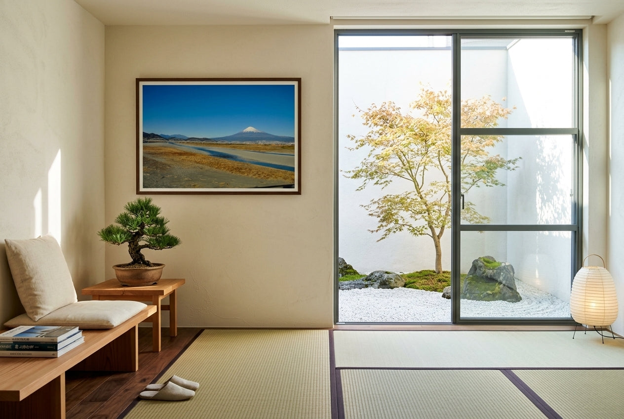 Mt Fuji and the Arched Bridge — Shinkansen View, framed in a Japanese-inspired garden room — floor-to-ceiling steel-framed glass door onto a dry-stone garden, low cedar bench, bonsai pine, paper lantern, dark wood frame. — Two Fat Bunnies.