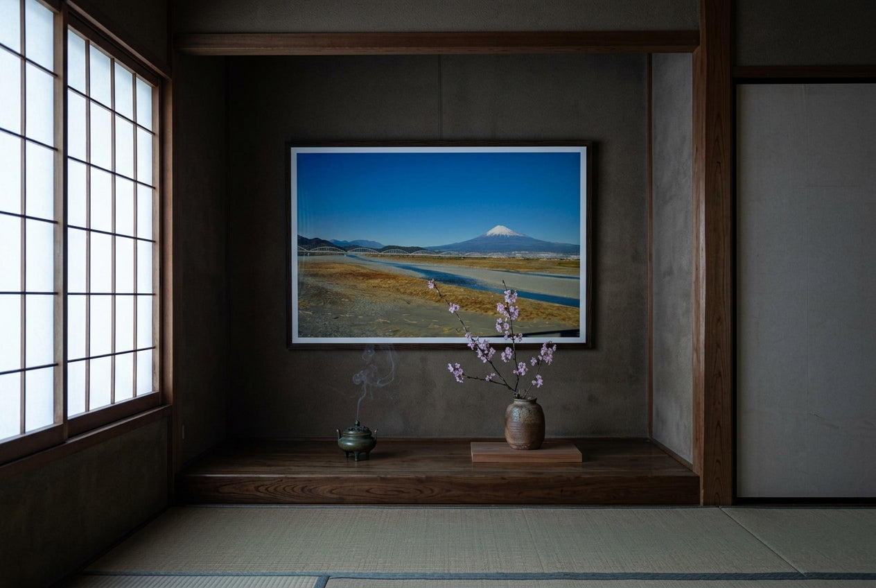 Mt Fuji and the Arched Bridge — Shinkansen View, framed in a tea-ceremony tokonoma alcove — dark cedar wall, tatami floor, bronze incense burner, ikebana cherry blossom, dark wood frame. — Two Fat Bunnies.