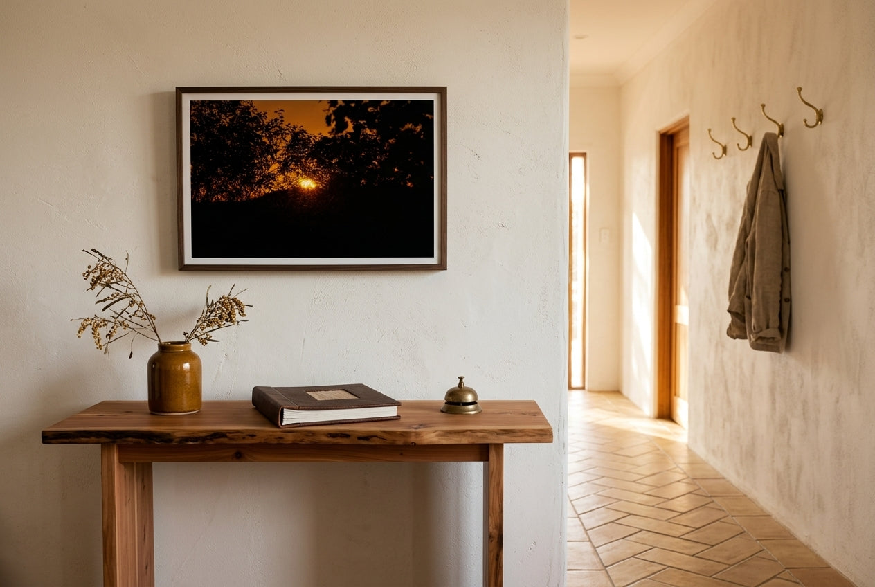 Ember Set at Buddy's Lookout, El Questro, framed above a slim cedar console in a contemporary Australian hallway — honey terracotta tile floor, dried wattle, brass coat hooks, dark wood frame. — Two Fat Bunnies.