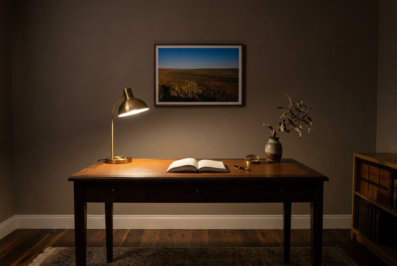 Golden Hour Across El Questro, Buddy's Lookout, framed above a heritage walnut writing desk in a compact home study — brass desk lamp, leather inlay, dark wood frame. — Two Fat Bunnies.