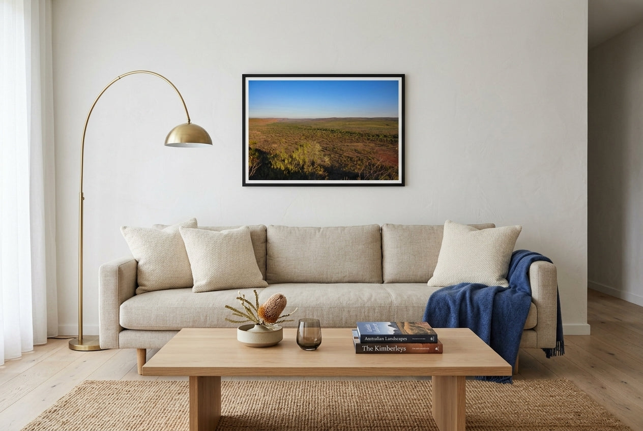 Golden Hour Across El Questro, Buddy's Lookout, framed in a modern Australian living room — oat linen sofa, woven jute rug, low oak coffee table, brass arc lamp, dark wood frame. — Two Fat Bunnies.