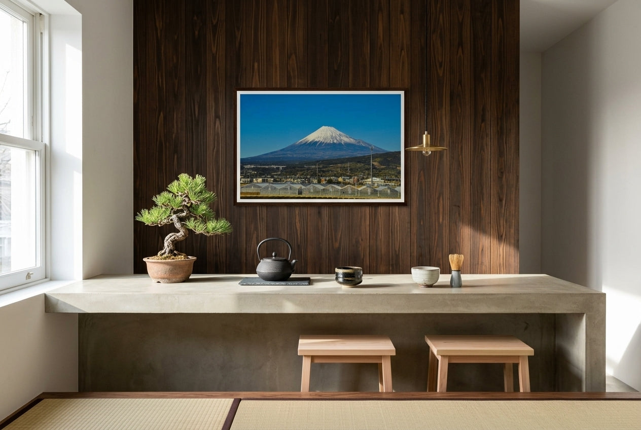 Mt Fuji in Motion: Shinkansen View, framed above a polished concrete kitchen counter — cedar feature wall, bonsai pine, cast-iron tea kettle, hand-thrown ceramic teabowls, brass pendant, dark wood frame. — Two Fat Bunnies.
