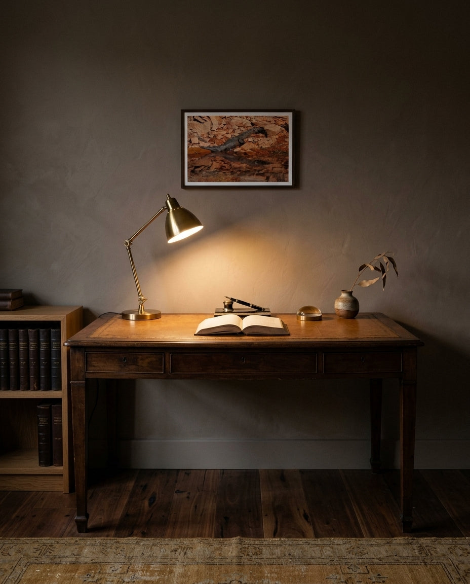 Sunlit Stillness — Freshwater Crocodile, Lake Argyle, framed in a contemplative home study — walnut writing desk, leather inlay, brass tungsten lamp, leather-bound books, dark wood frame. — Two Fat Bunnies.