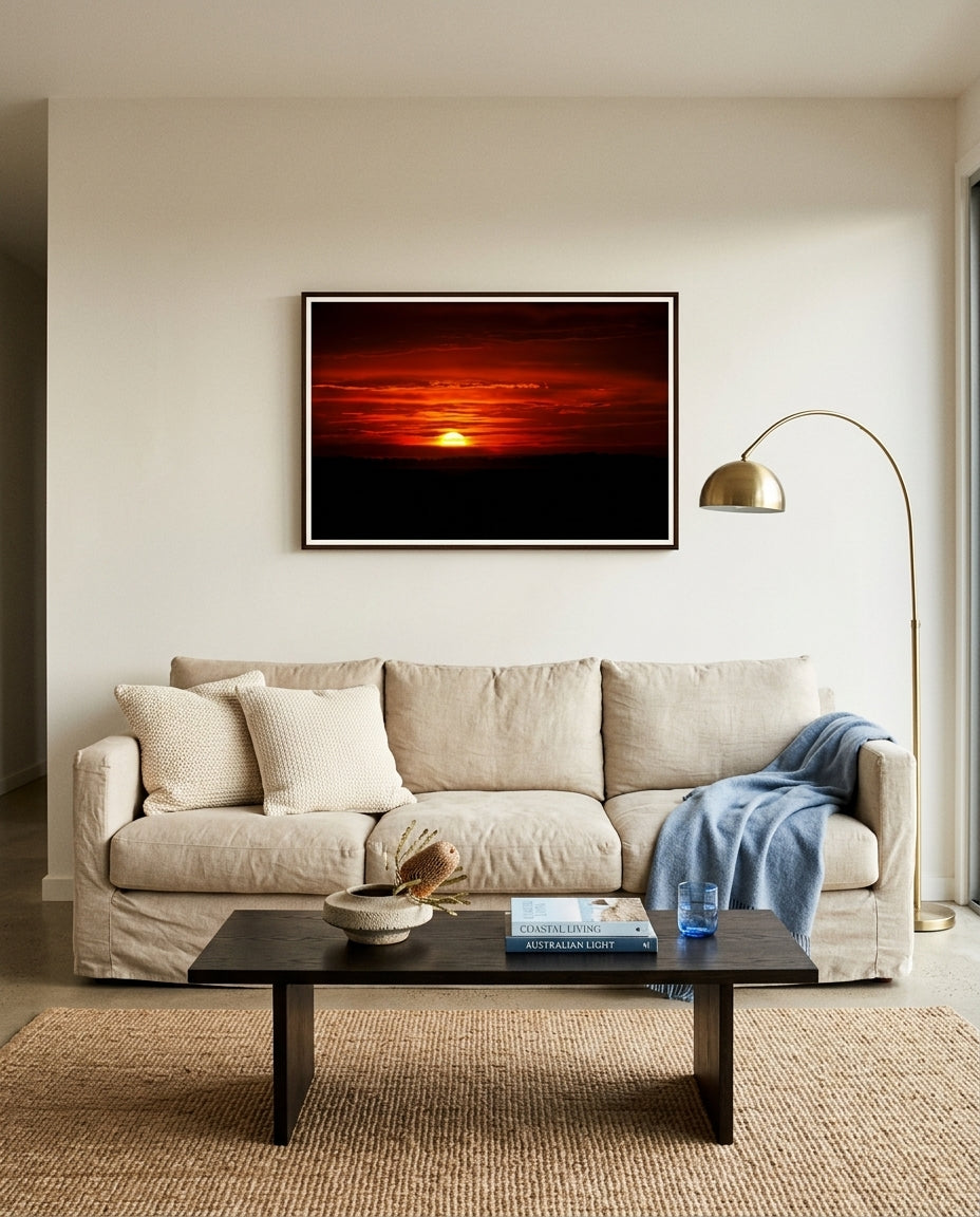 Sunrise Over Bass Strait – Flinders, framed above a linen sofa in a coastal living room — woven jute rug, ceramic table lamp, dried sea-grass in a stoneware vessel, pale oak coffee table, dark wood frame. — Two Fat Bunnies.